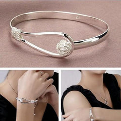 Silver bangle with flower detail